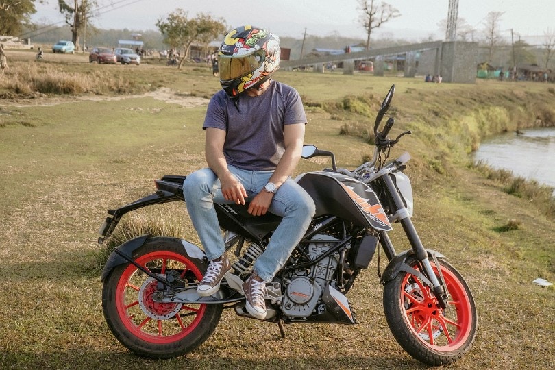 man resting on his motorcycle