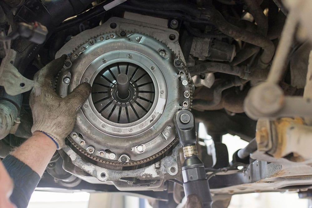 mechanic replacing clutch disc