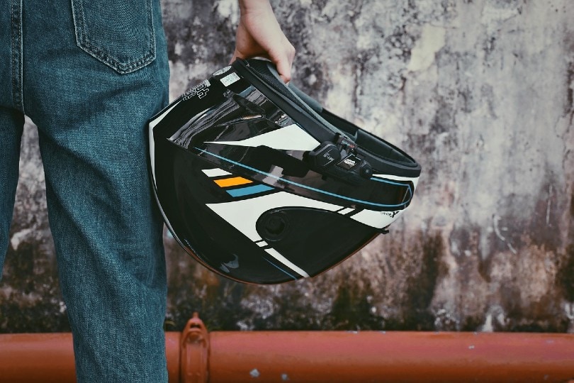 motorcycle rider holding his helmet