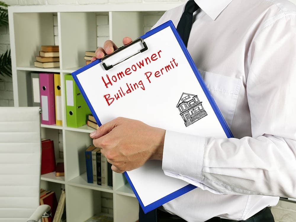 person holding a building permit