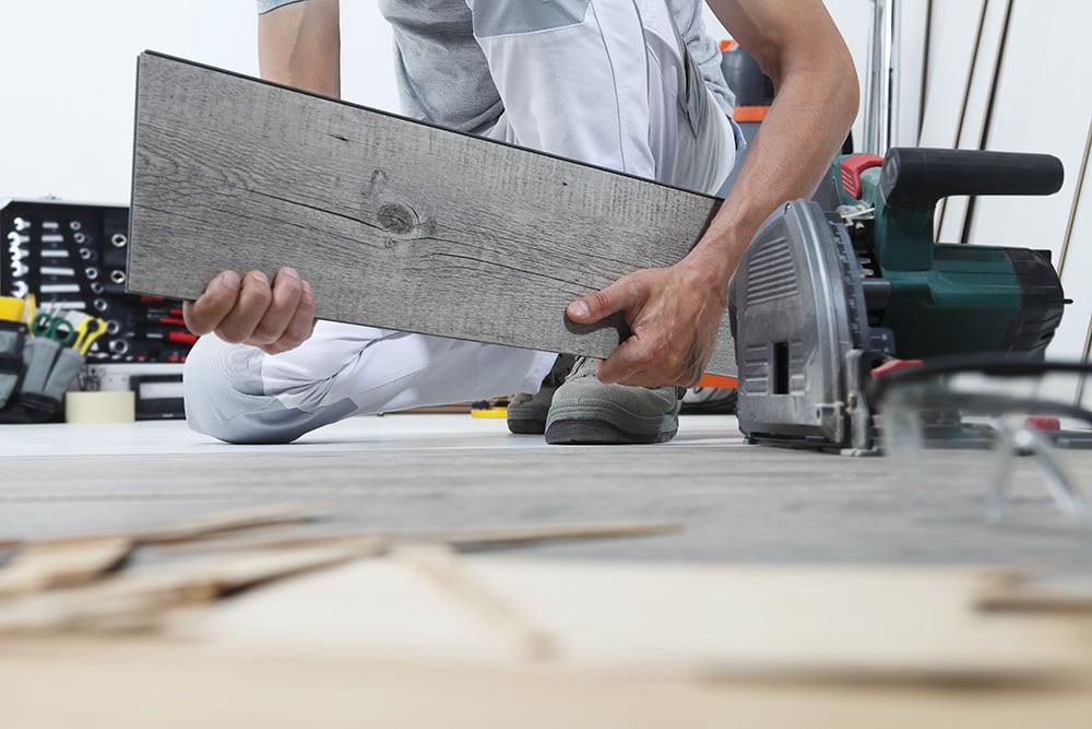 person holding laminated flooring