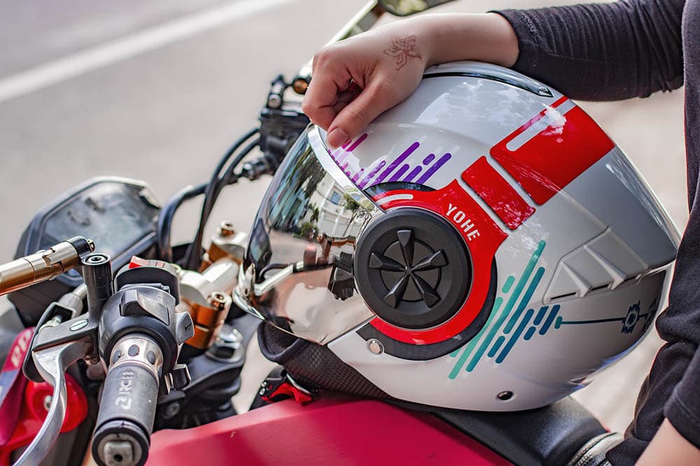 person sitting on a motorcyle with helmet