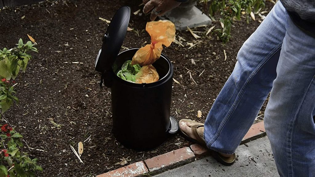 person throwing dog poop bags on Premium Dog Waste Trash Can