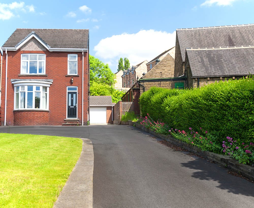 red brick house with asphalt driveway