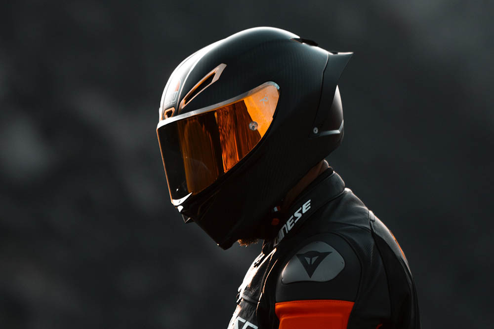 rider wearing black race suit and helmet