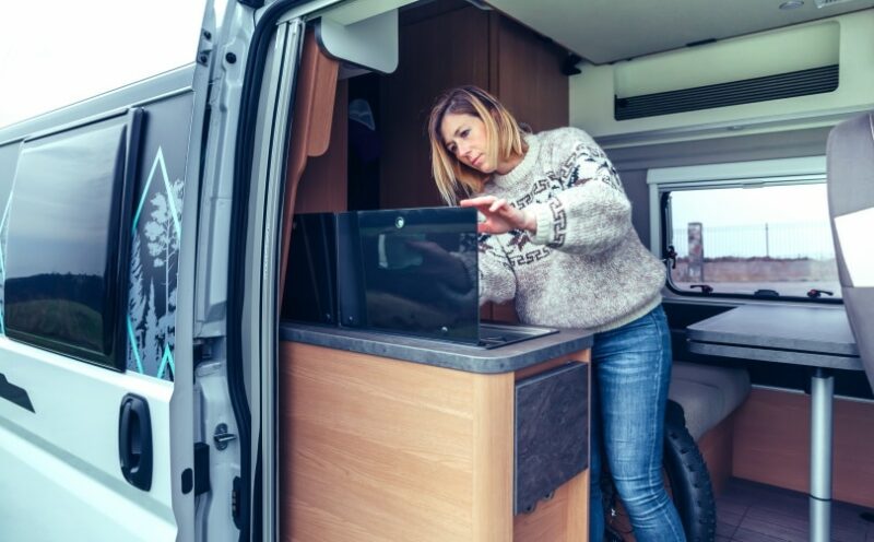 woman cleaning RV interior