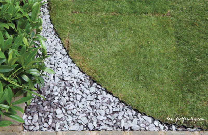 DIY shaping a lawn with slate chippings