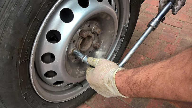 a mechanic fixing car's tire