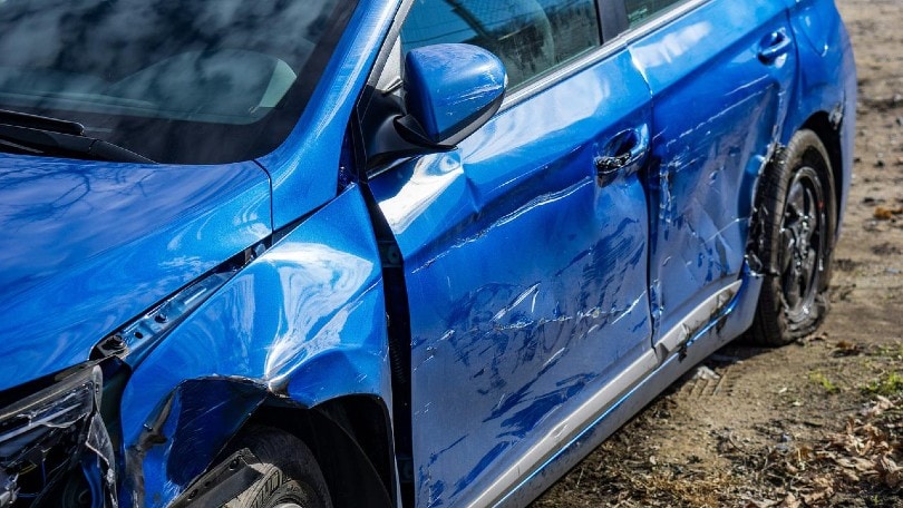 blue car severely dented by an accident