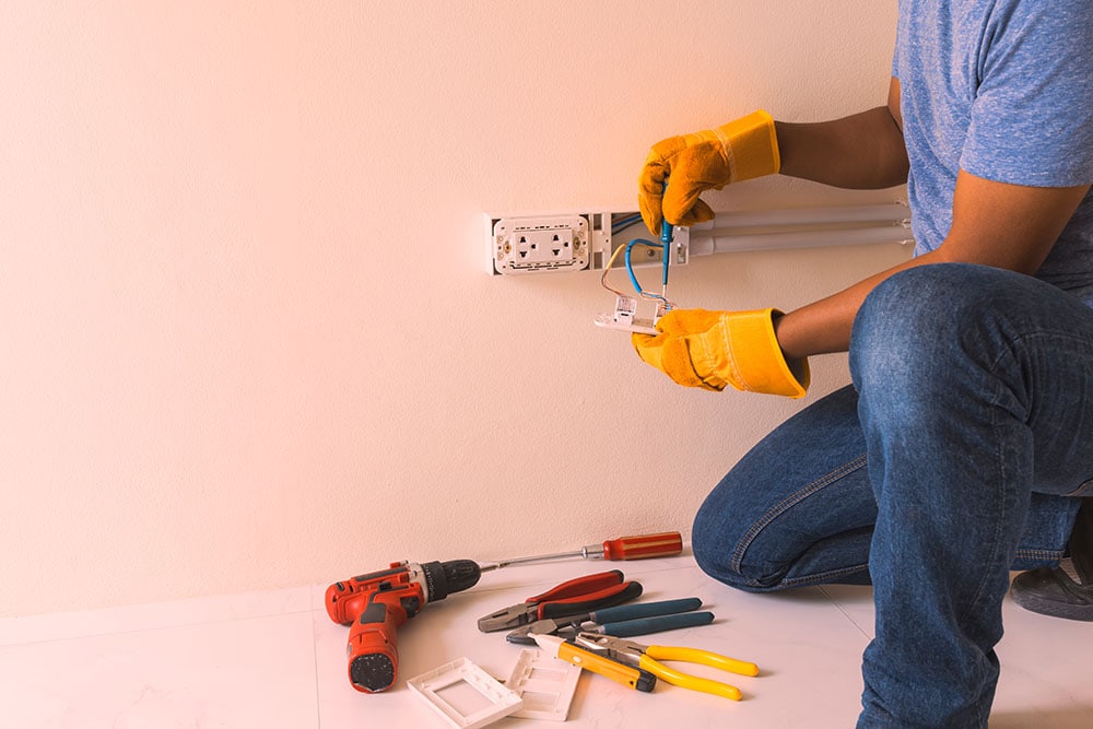 electrician installing power outlet