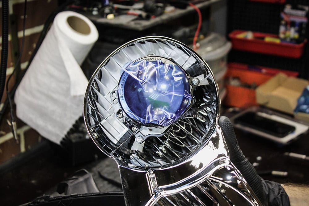 mechanic holding a reflector headlight