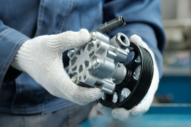 power steering pump hold by mechanic