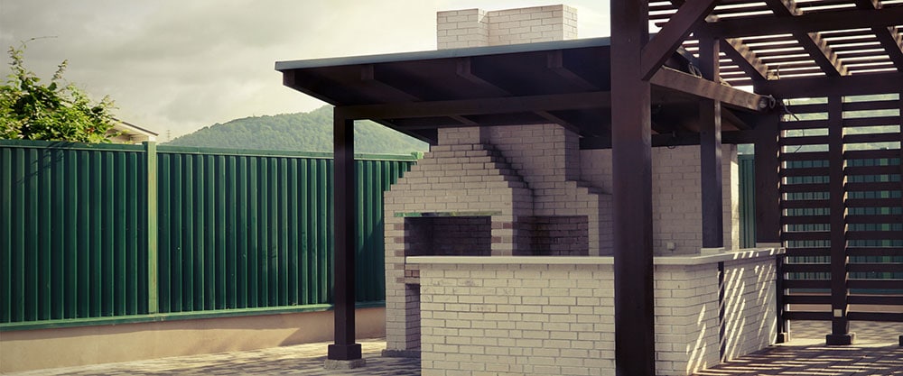 white brick smoker with roof