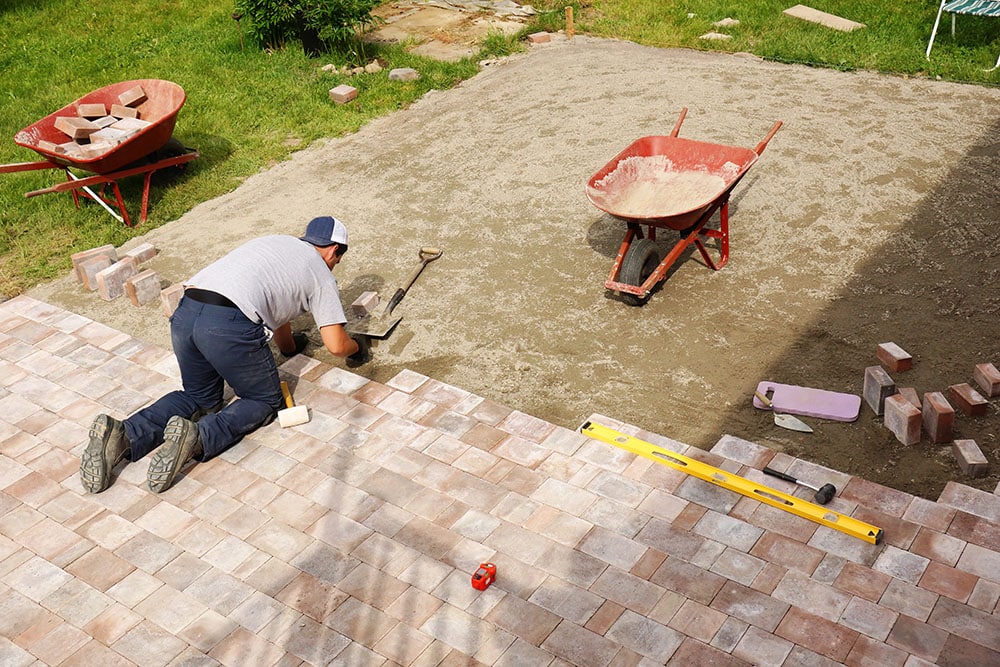 Young professional paver worker at work