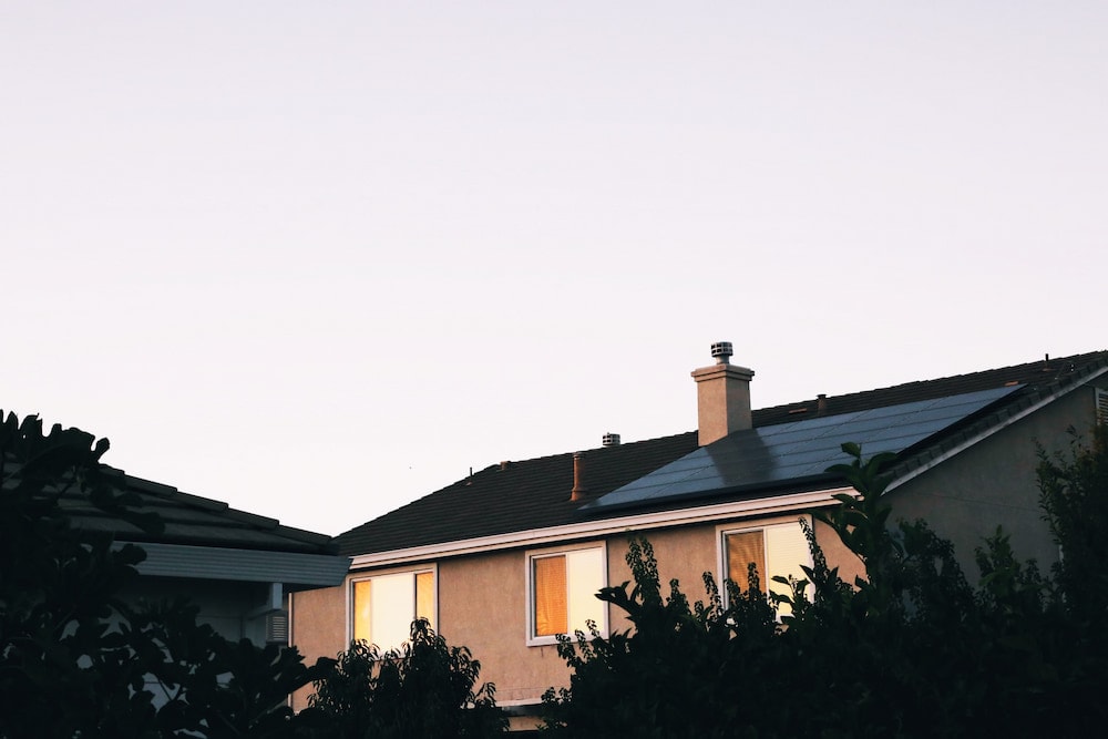 brown and white concrete house with black roof