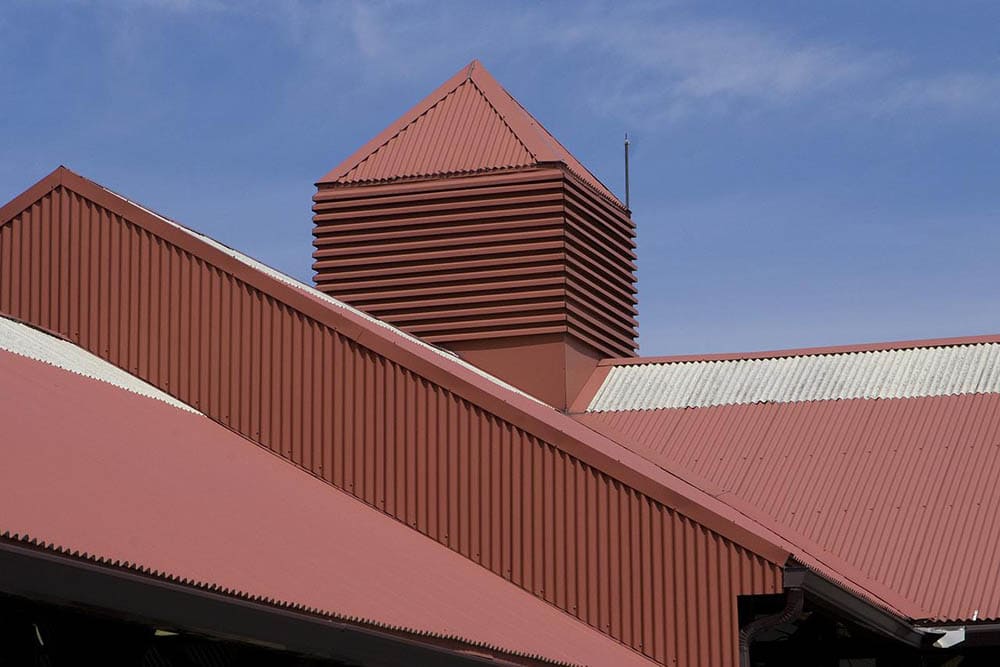 building with red metal roofing