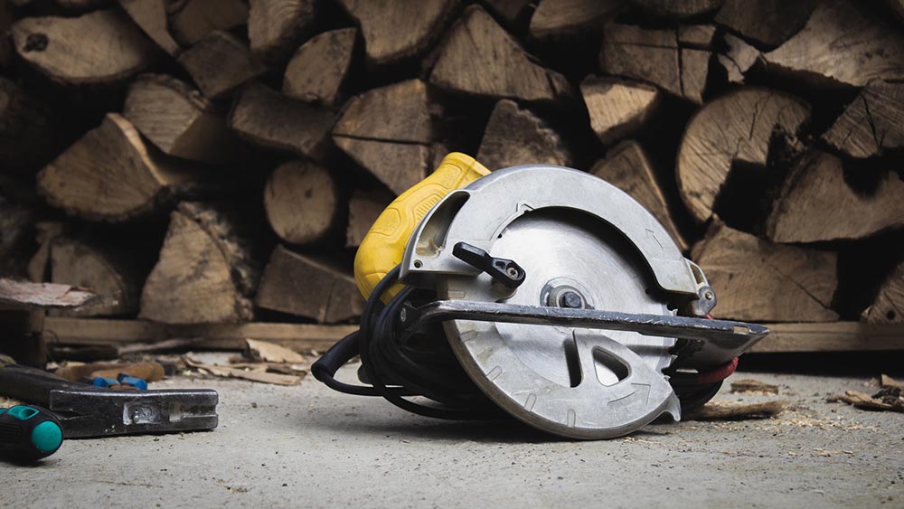 circular saw in front of stacks of lumber