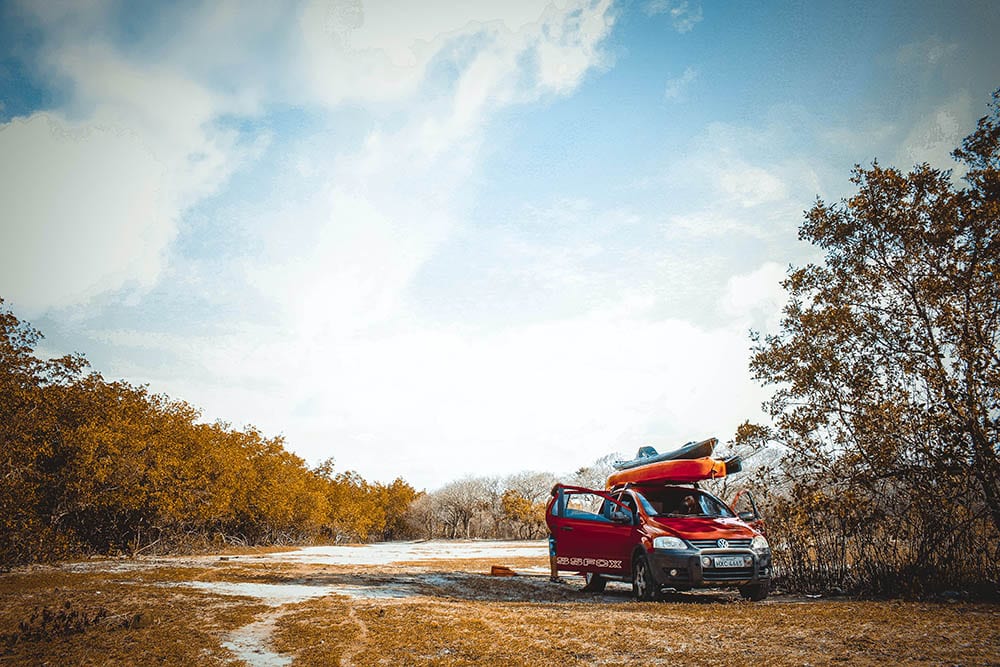 kayak on top of red vehicle_GlauberSampaio_Unsplash