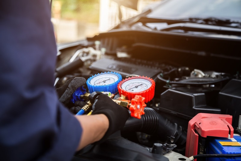 man checking car AC