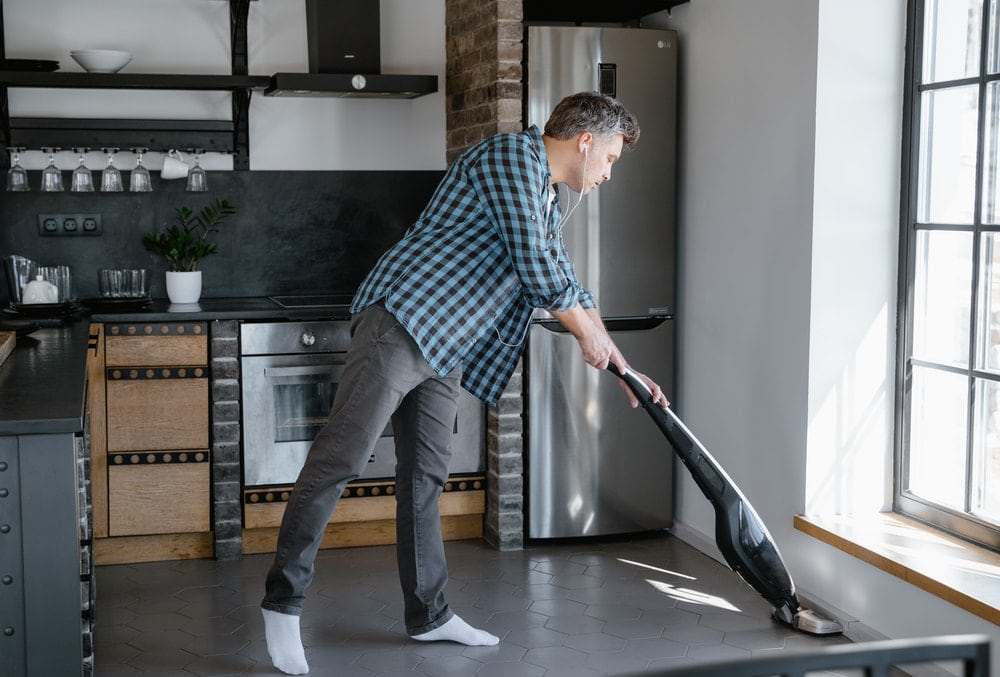 man cleaning the kitchen floor