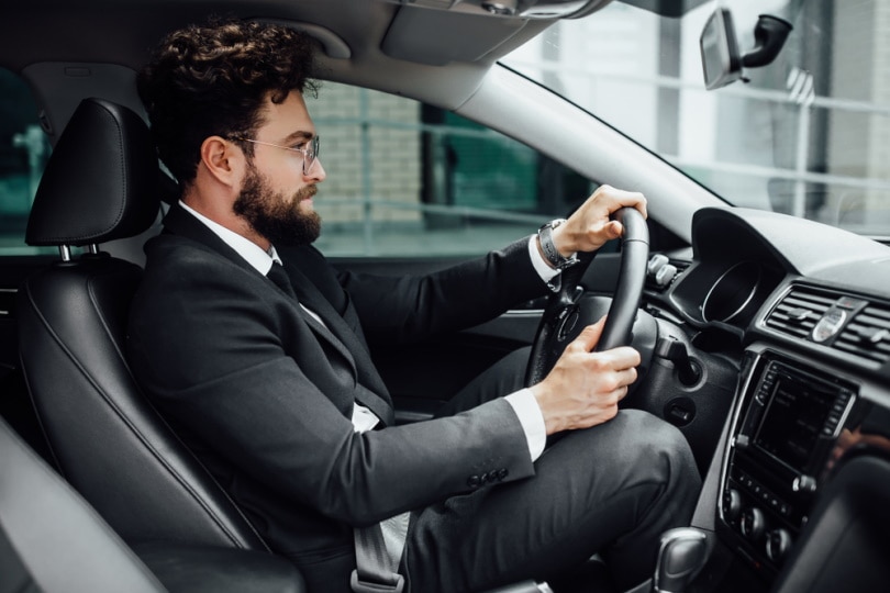 man driving car