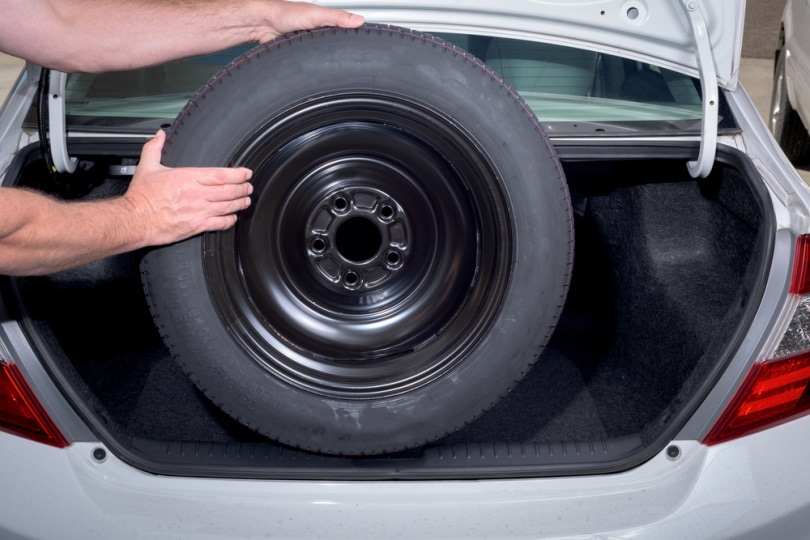 man holding spare tire