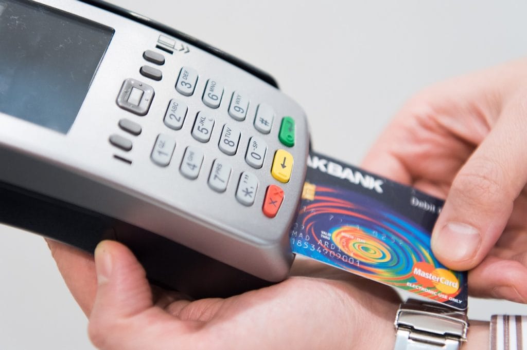 man paying with credit card