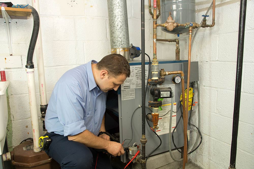 man repairing gas furnace