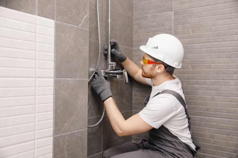 mans installing shower