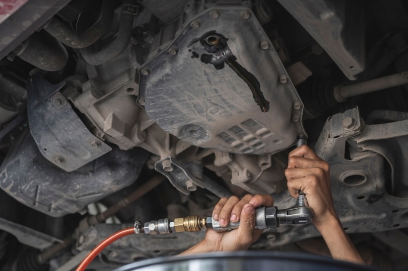 mechanic checking automatic transmis