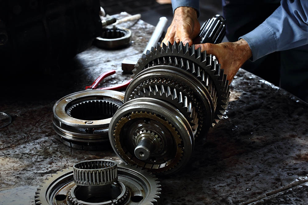 mechanic fixing car transmission