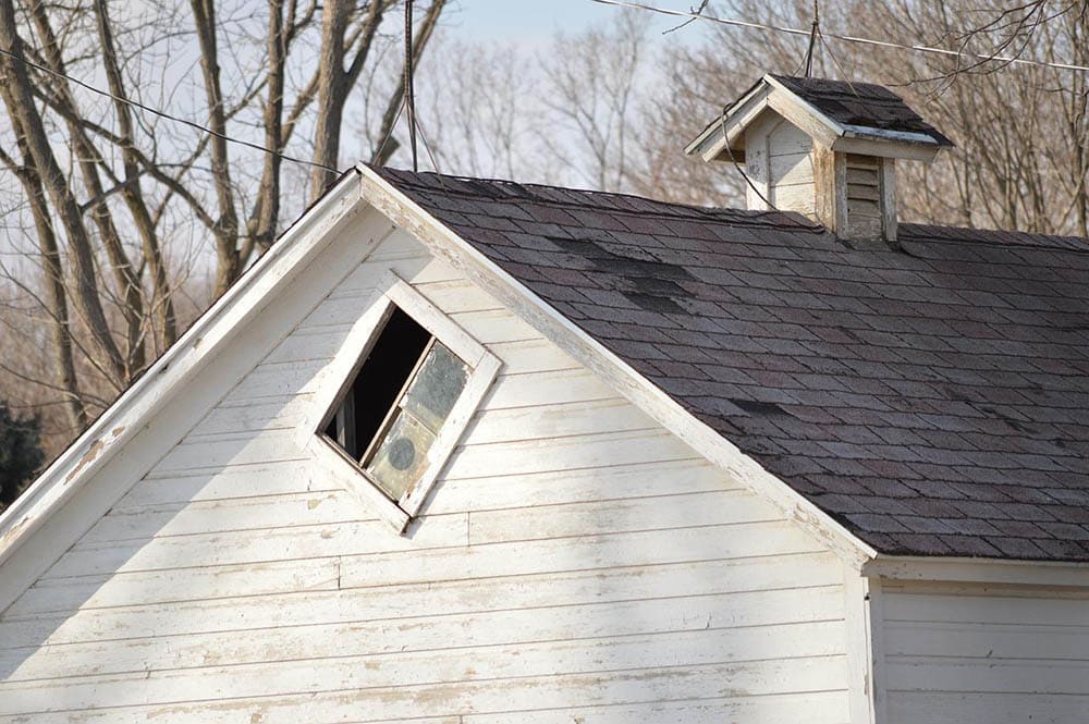 old house with 3-tab shingles roof
