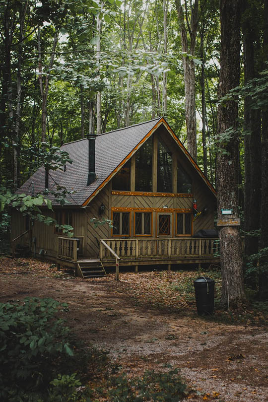 olive house with brown roof