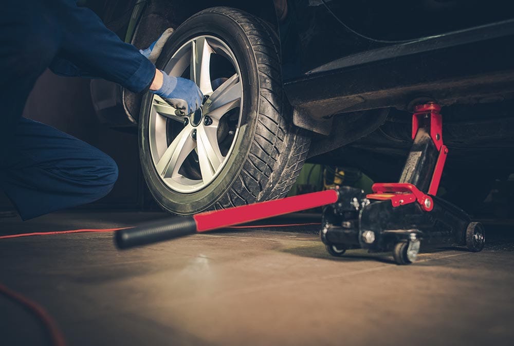 person changing car tire