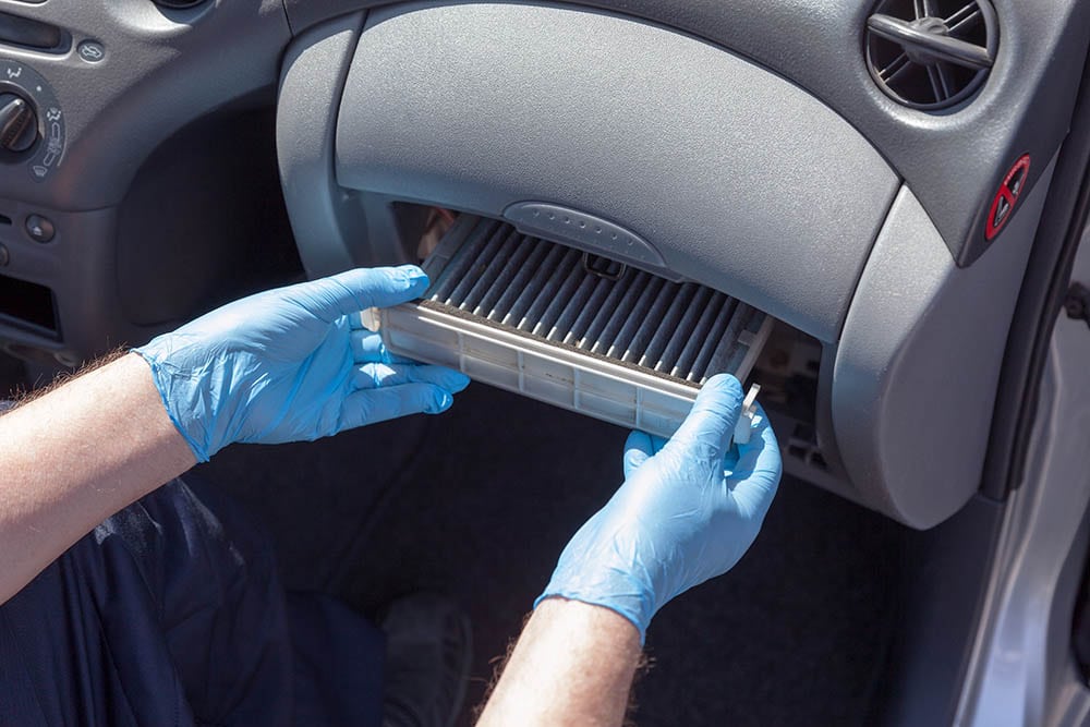 person removing the cabin air filter