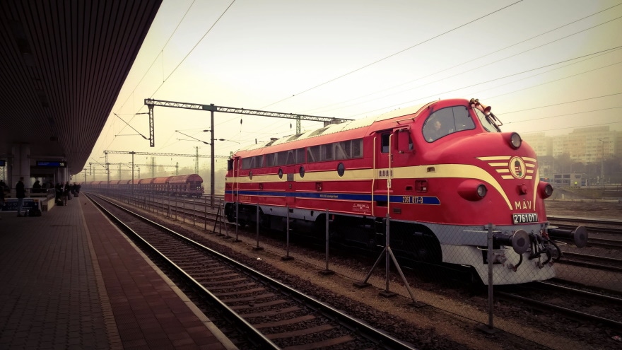 red train in railroad