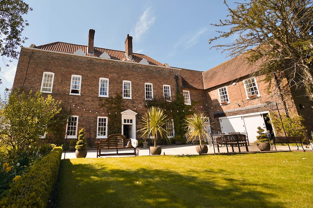 two-storey brick house with brown roof