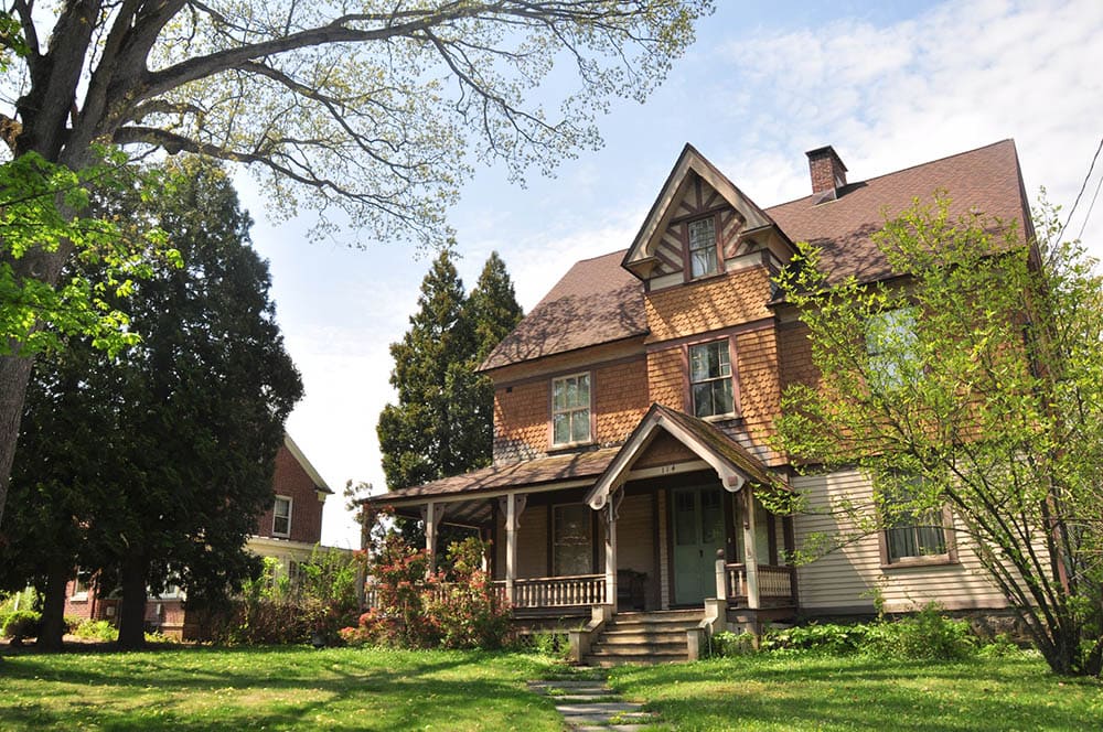 two-storey tan house with brown roof