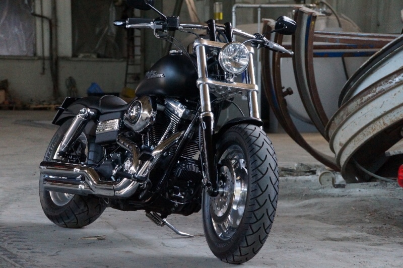 Black harley davidson motorcycle with H-bar handlebars