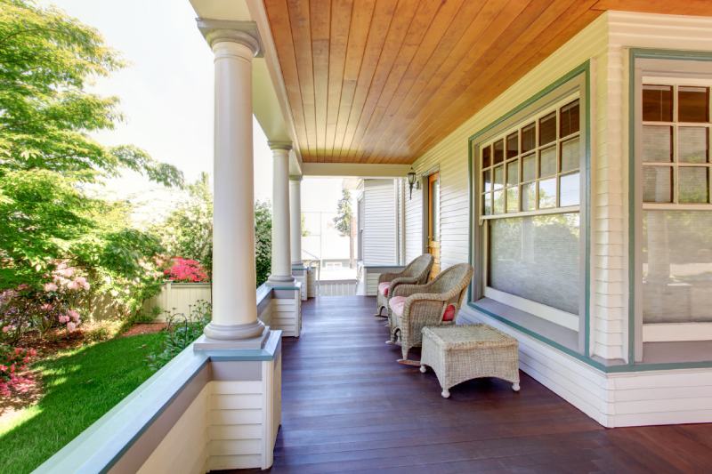 Front porch with chairs and columns of craftsman style home