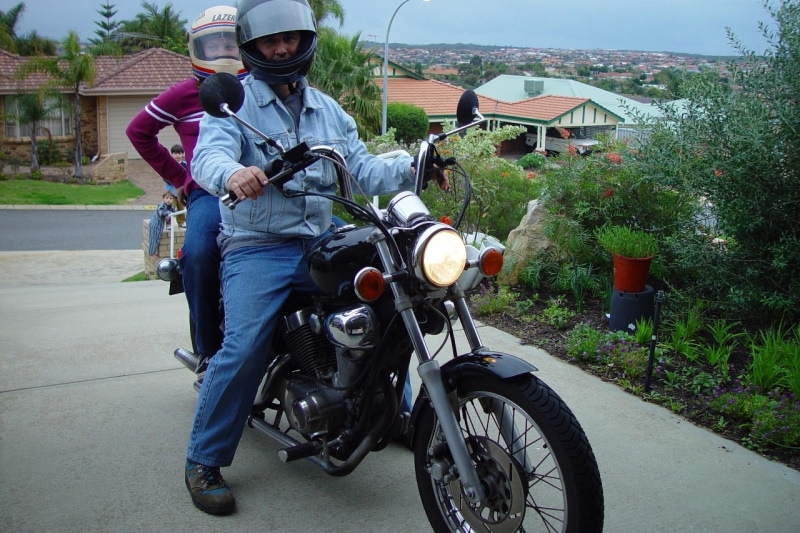 Man and woman on a mottorcycle with breezer handlebars