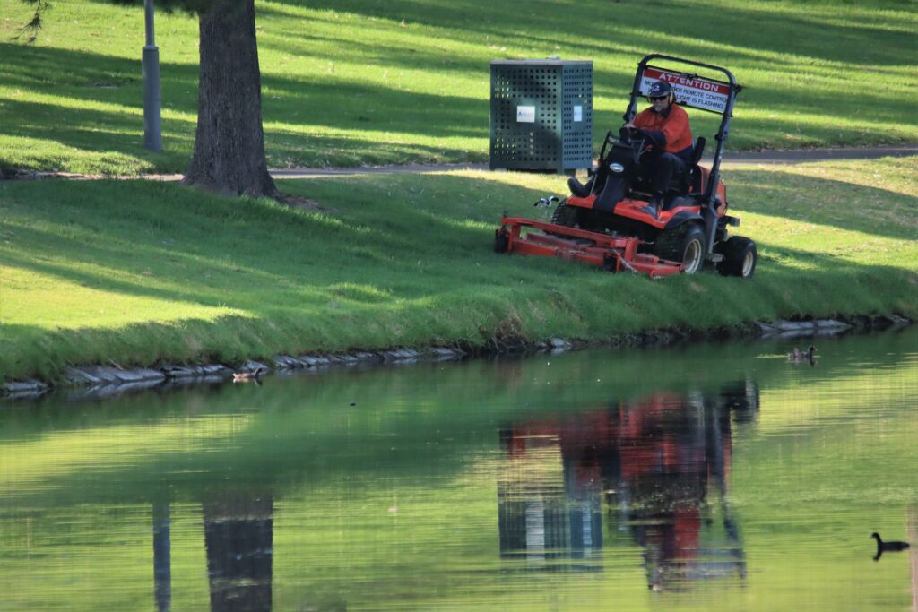 Riding lawn mower near river