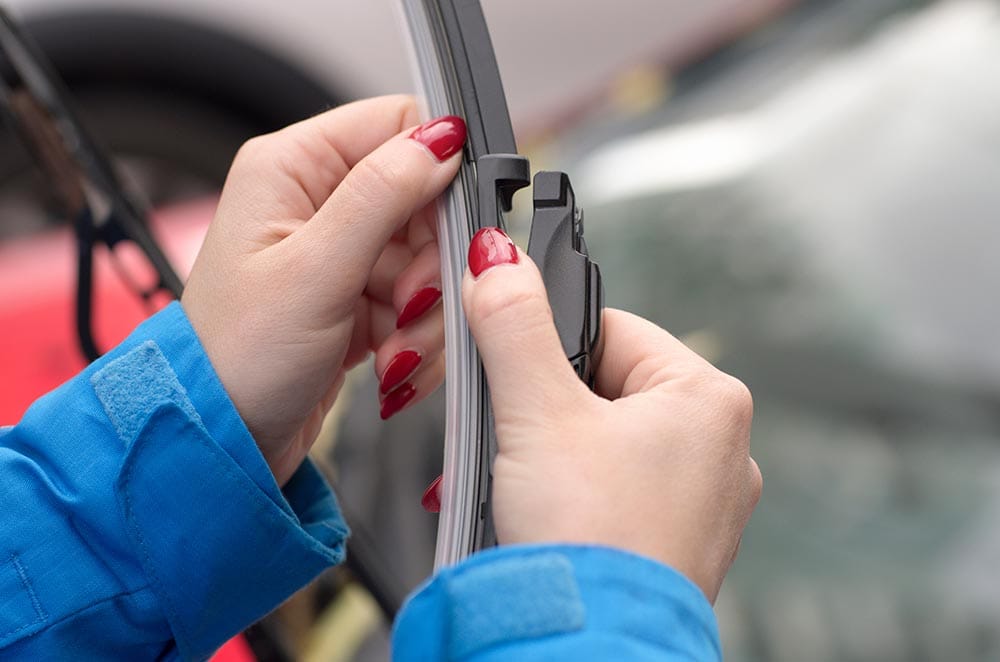 close up hands holding windshield wiper