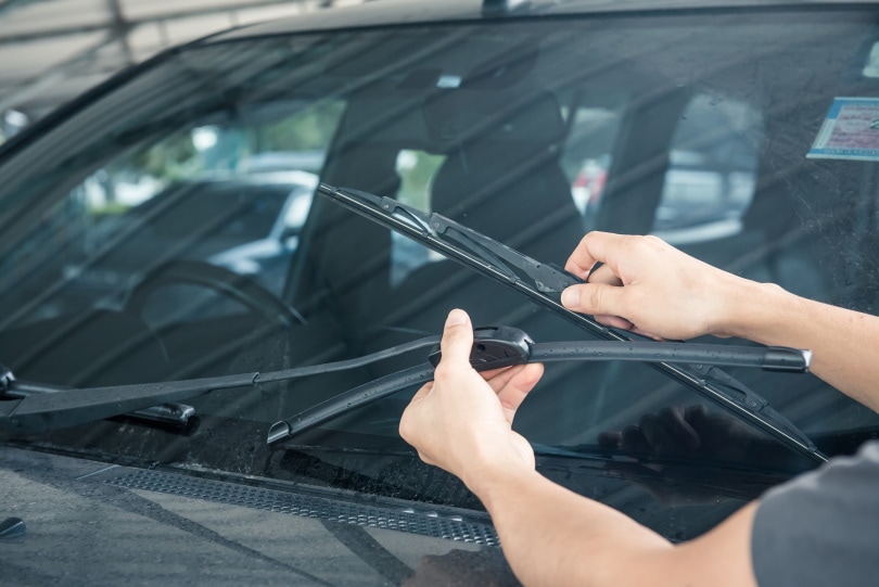 man holding windshield wipers