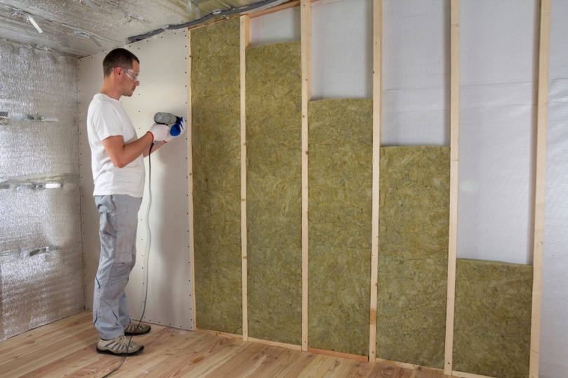 man installing insulation