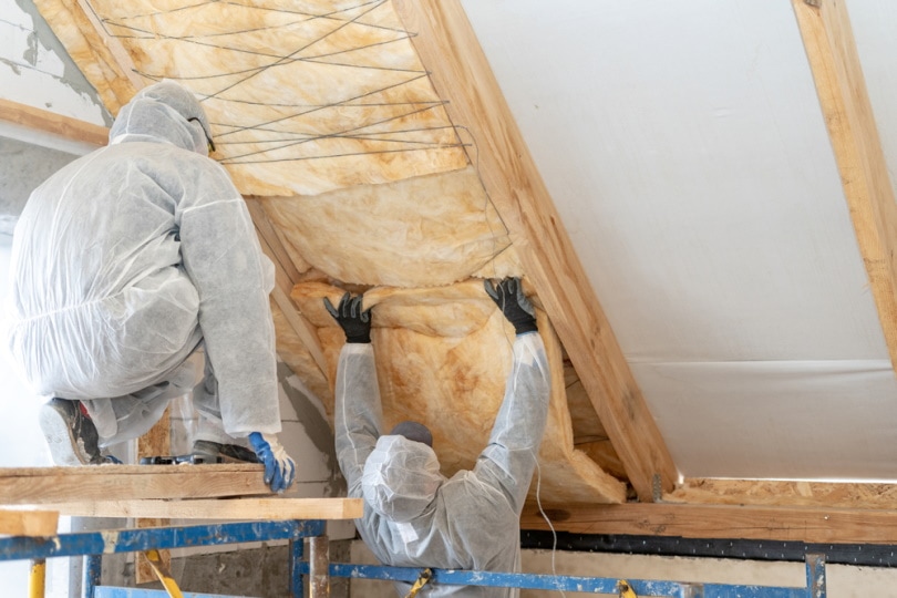 man installing rockwool insulation