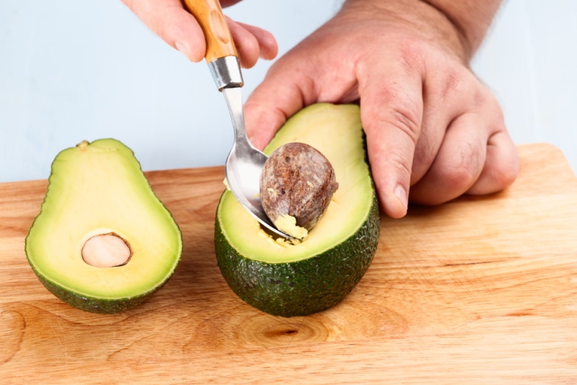 man removing avocado seed