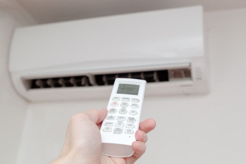 man using airconditining remote