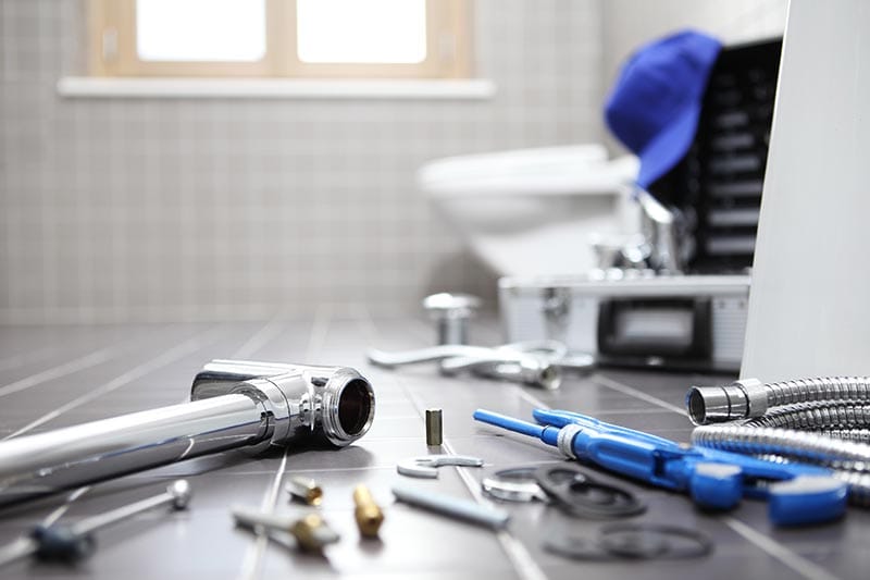 plumber tools and equipment in a bathroom, plumbing repair service