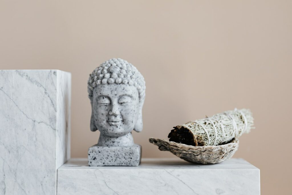 stone buddha on marble shelf